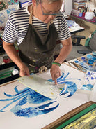 Artist painting blue crab